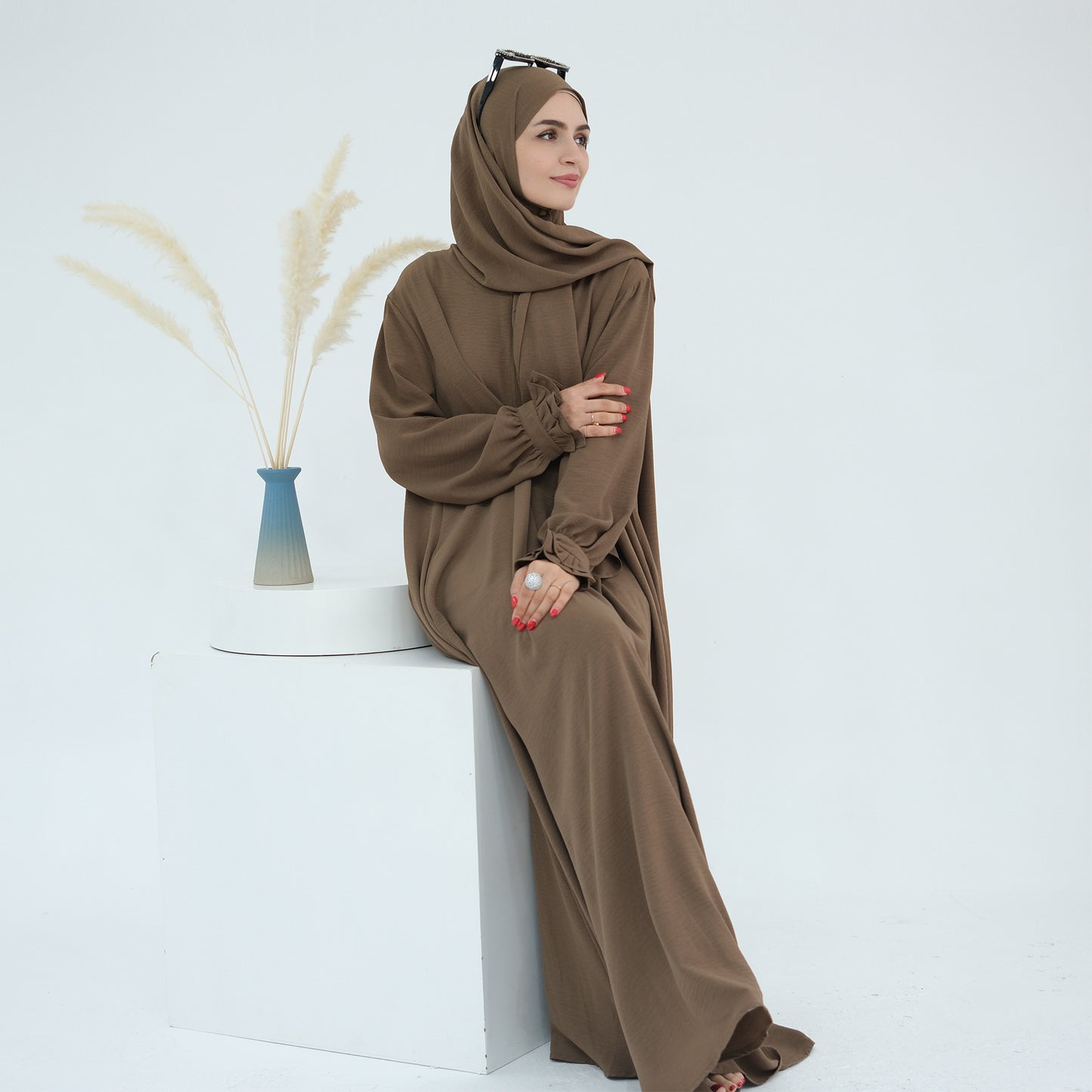 Douceur & élégance dans un style moderne. Découvrez cette abaya au design fluide et léger, sublimée par ses manches à volants délicates